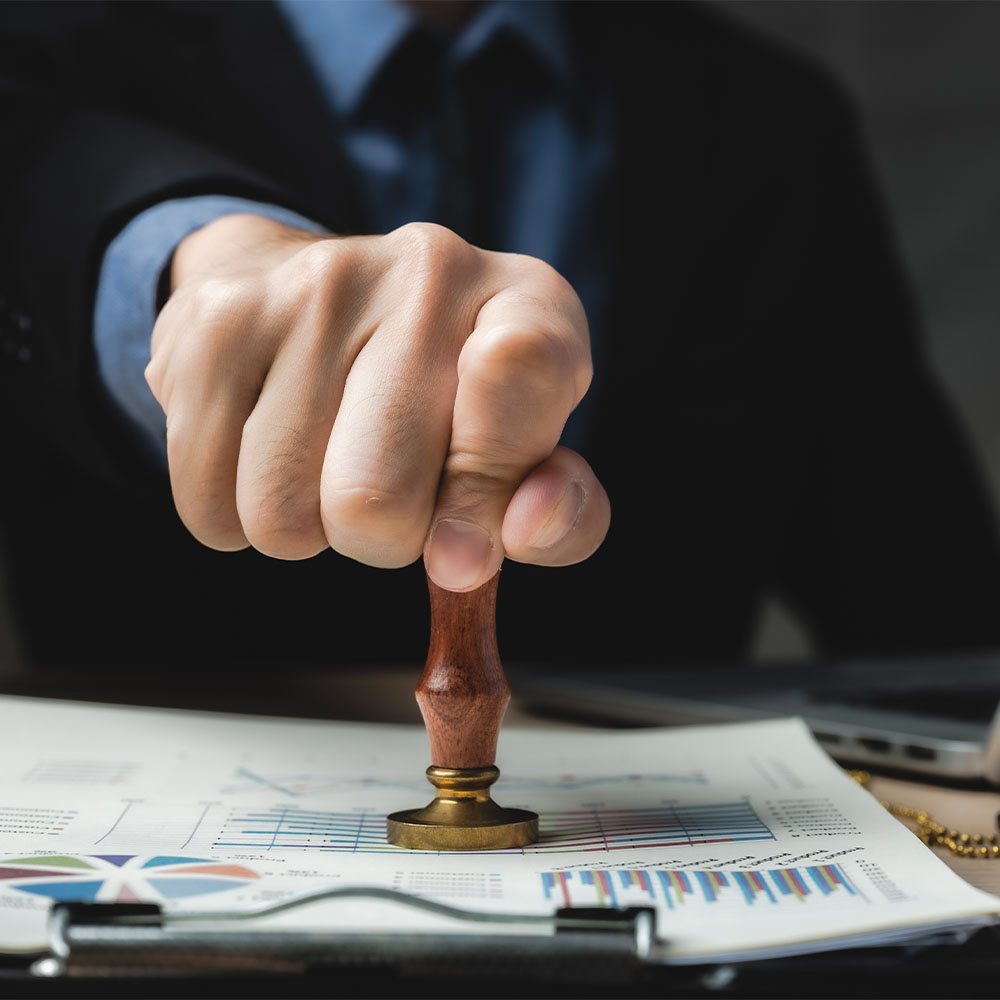 LEGAL_0003_person-s-hand-stamping-with-approved-stamp-business-marketing-document-desk-modern-office