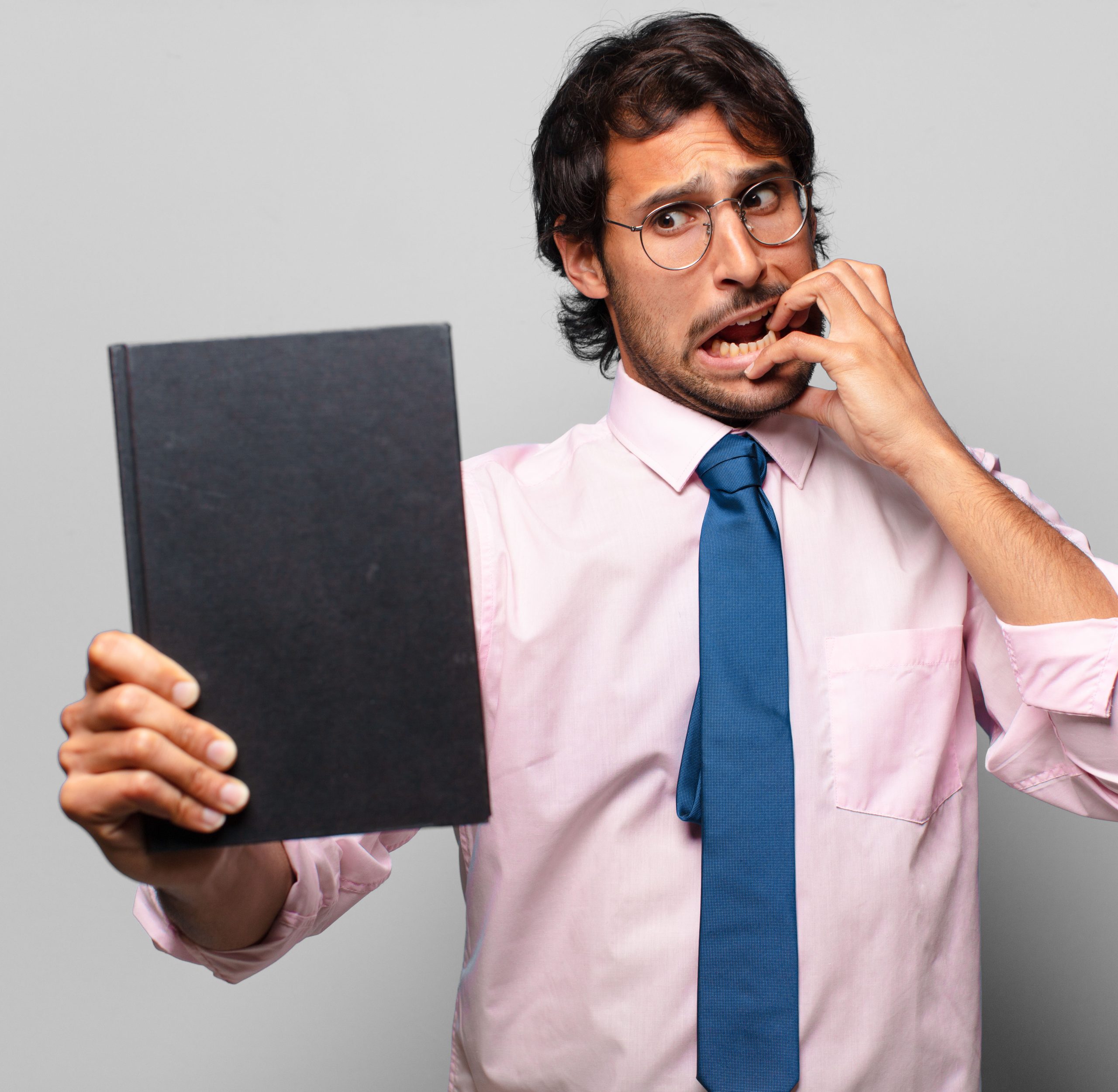 adult handsome indian businessman holding a book
