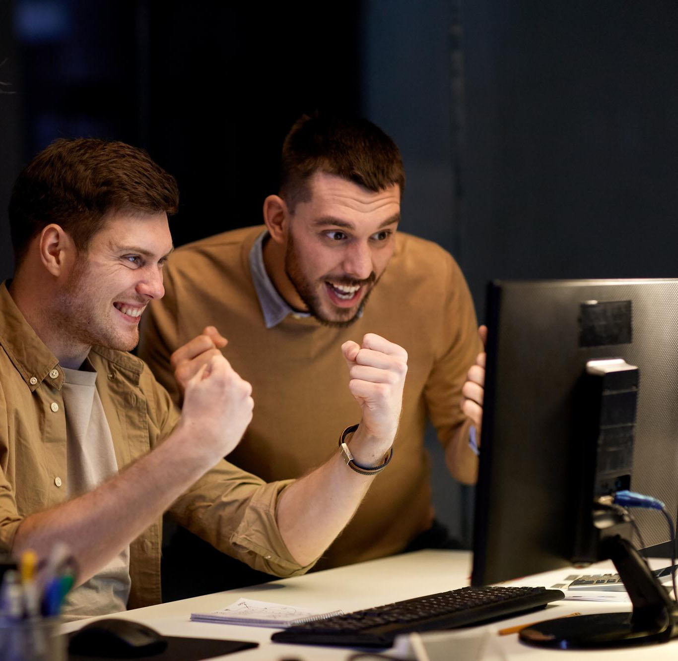 business-success-teamwork-concept-happy-coworkers-with-computer-celebrating-victory-night-office