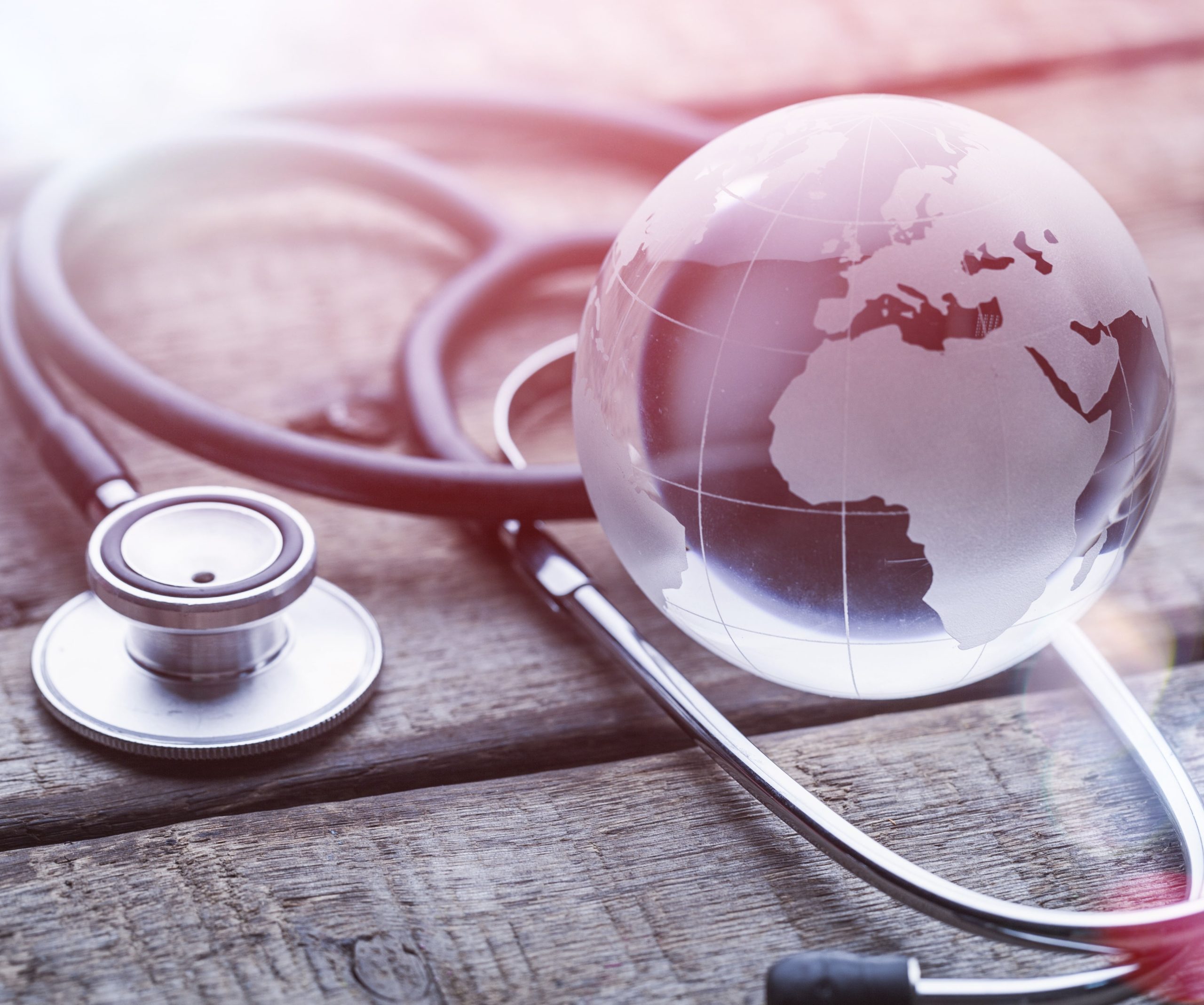 glasd global and stethoscope on wood table, healthcare concept, world environment day,